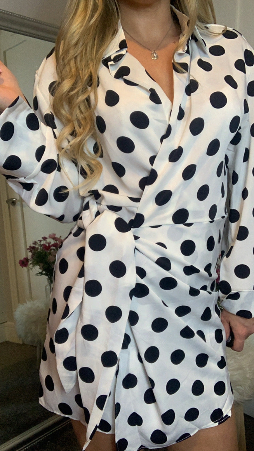 Wrap dress with black & white polka dot pattern, long sleeve & collared v- neckline.