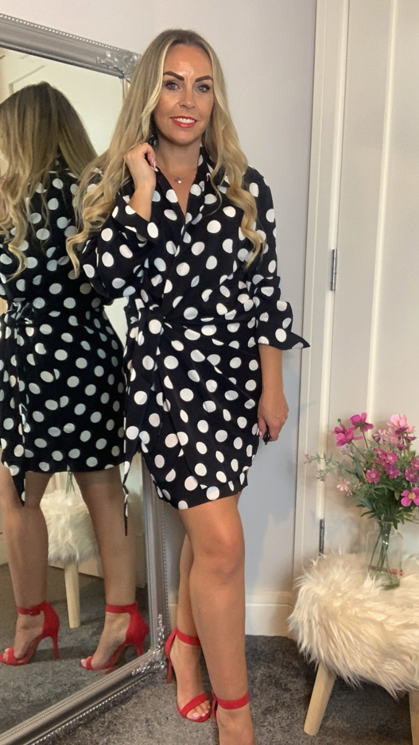 Wrap dress with black & white polka dot pattern, long sleeve & collared v- neckline.