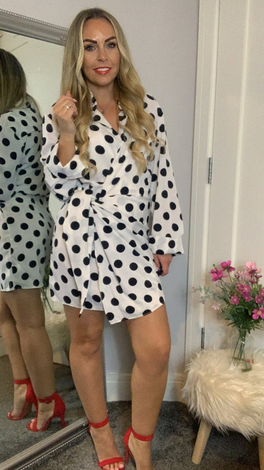 Wrap dress with black & white polka dot pattern, long sleeve & collared v- neckline.