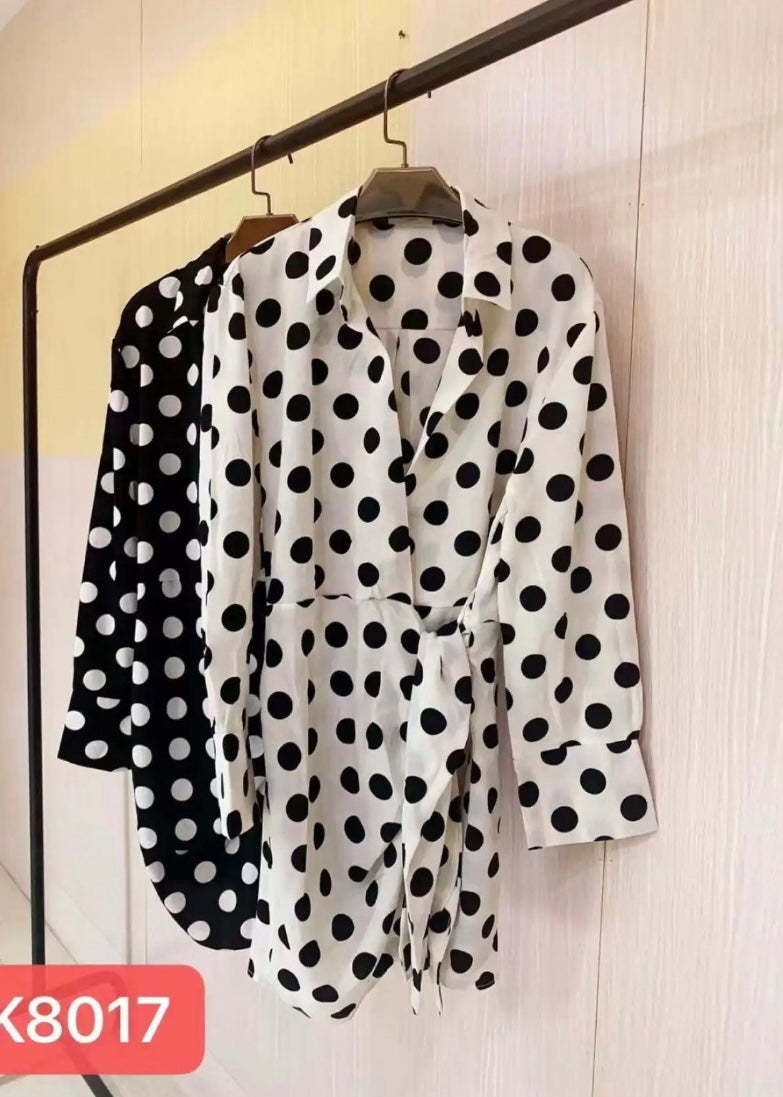 Wrap dress with black & white polka dot pattern, long sleeve & collared v- neckline.